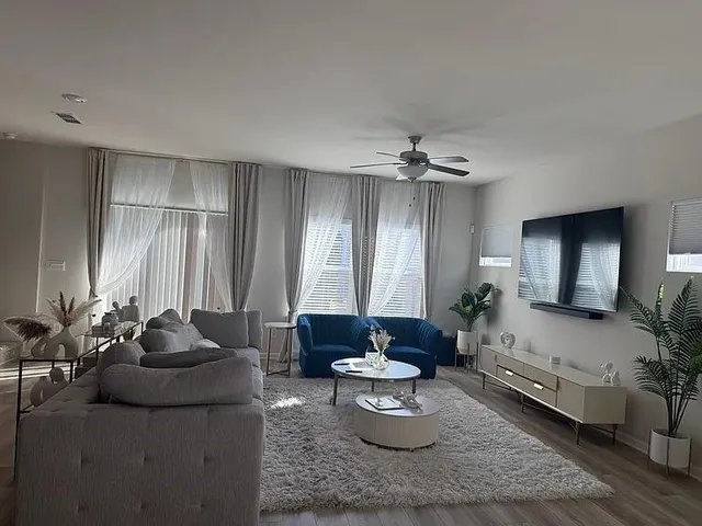 a living room with furniture and a chandelier