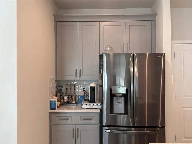 a kitchen with a refrigerator and cabinets