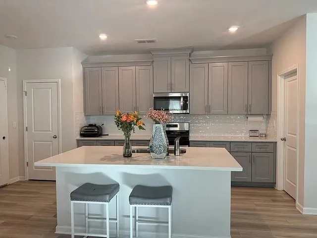 a kitchen with a sink cabinets and appliances