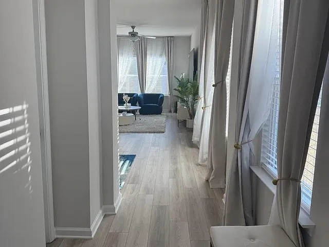 a view of a hallway view with wooden floor and furniture