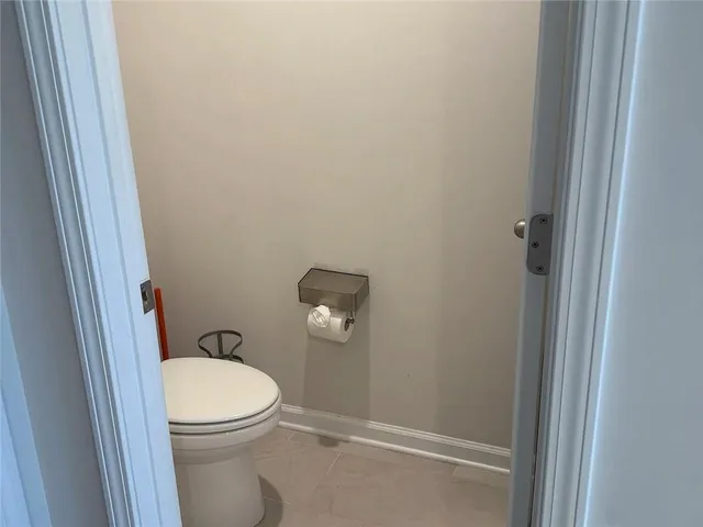 a white toilet sitting next to a shower
