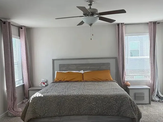 a bedroom with a bed and window