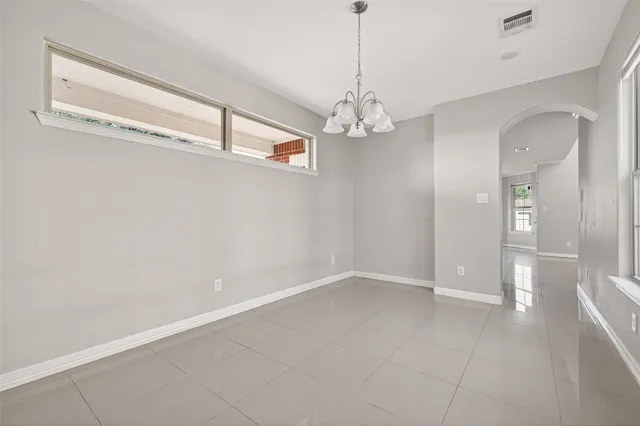 a view of a chandelier and a chandelier fan in a room