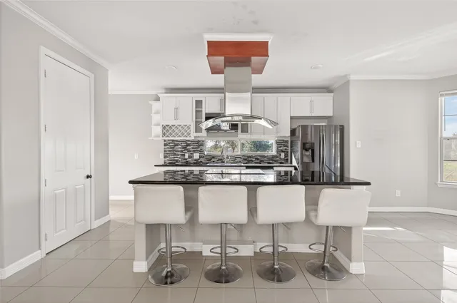 a kitchen with a table and chairs