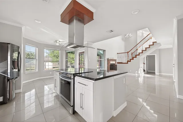 a kitchen with stainless steel appliances granite countertop a sink and a refrigerator