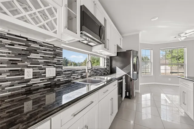 a kitchen with stainless steel appliances a sink a stove and a oven