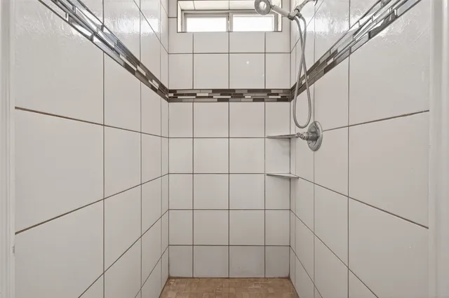 a bathroom with a tub sink and mirror
