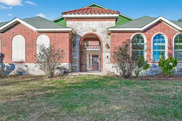 a front view of a house with garden