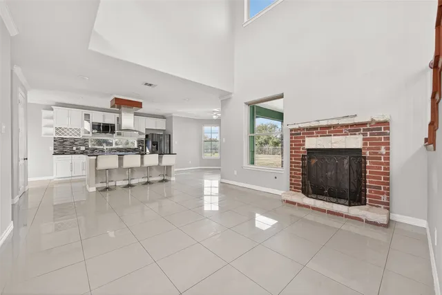 a living room with furniture a fireplace and a table
