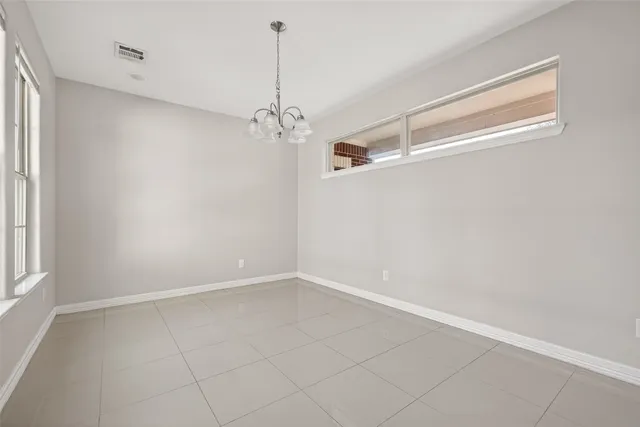 a view of a room with a window and chandelier fan