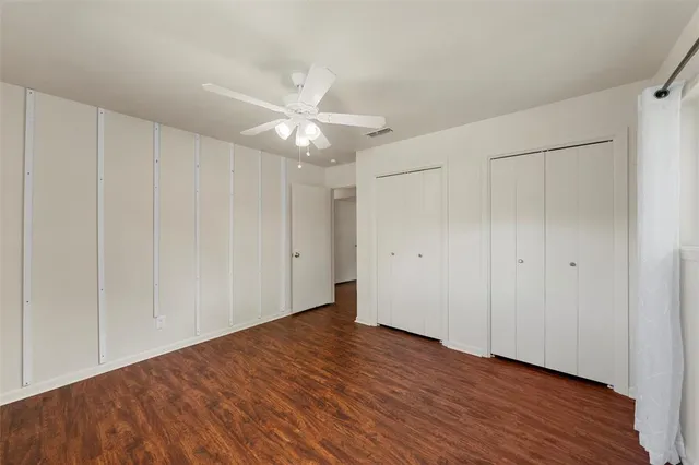 a bathroom with a granite countertop sink toilet a mirror and shower