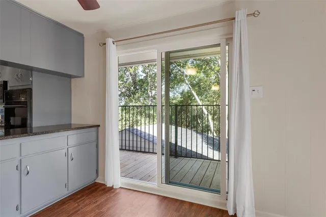a bathroom with a granite countertop sink a toilet a mirror and shower
