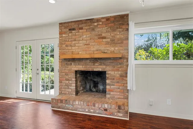 a kitchen with stainless steel appliances granite countertop a sink a stove a refrigerator and island with wooden floor