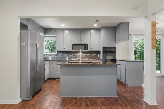 a living room with a fireplace and wooden floor