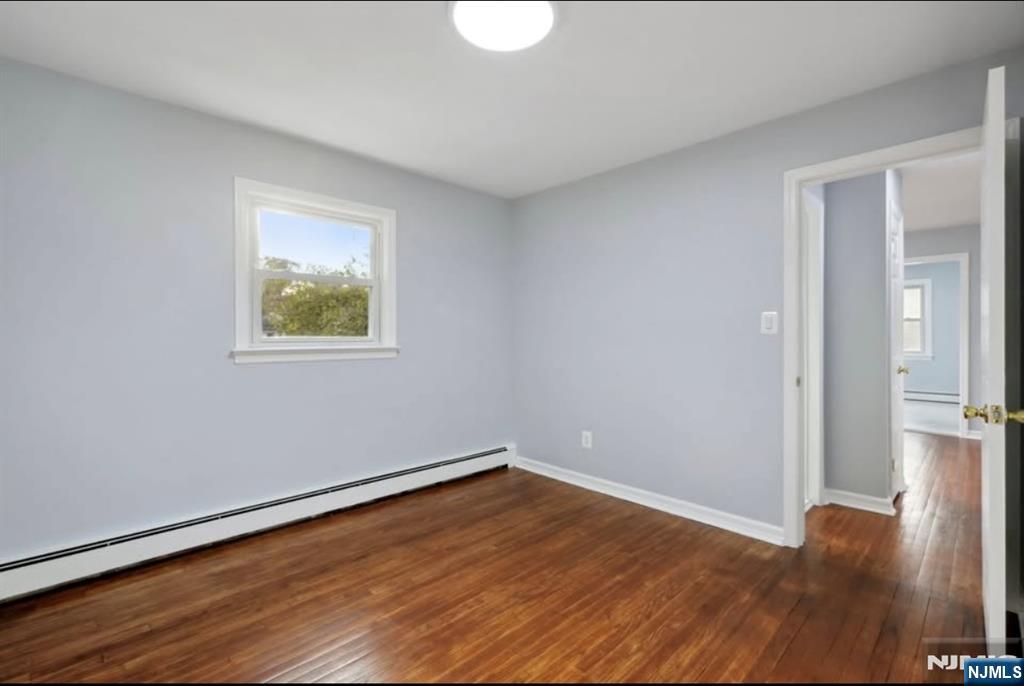 162 East Fairmount Avenue, Unit 2 Maywood, NJ 07607 - Photo 16 of 21 a view of an empty room with wooden floor and a window