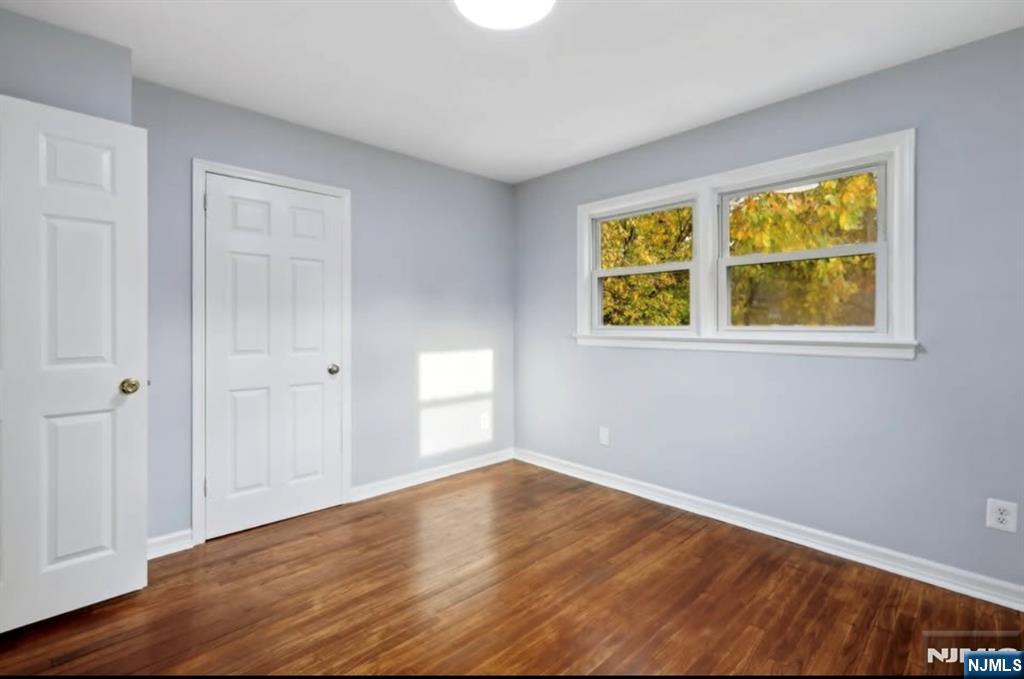 162 East Fairmount Avenue, Unit 2 Maywood, NJ 07607 - Photo 20 of 21 a view of an empty room with wooden floor and a window