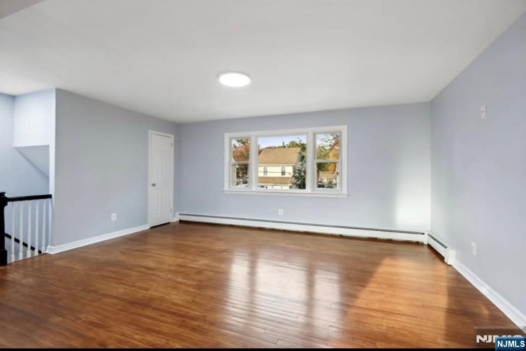 162 East Fairmount Avenue, Unit 2 Maywood, NJ 07607 - Photo 4 of 21 an empty room with wooden floor and windows
