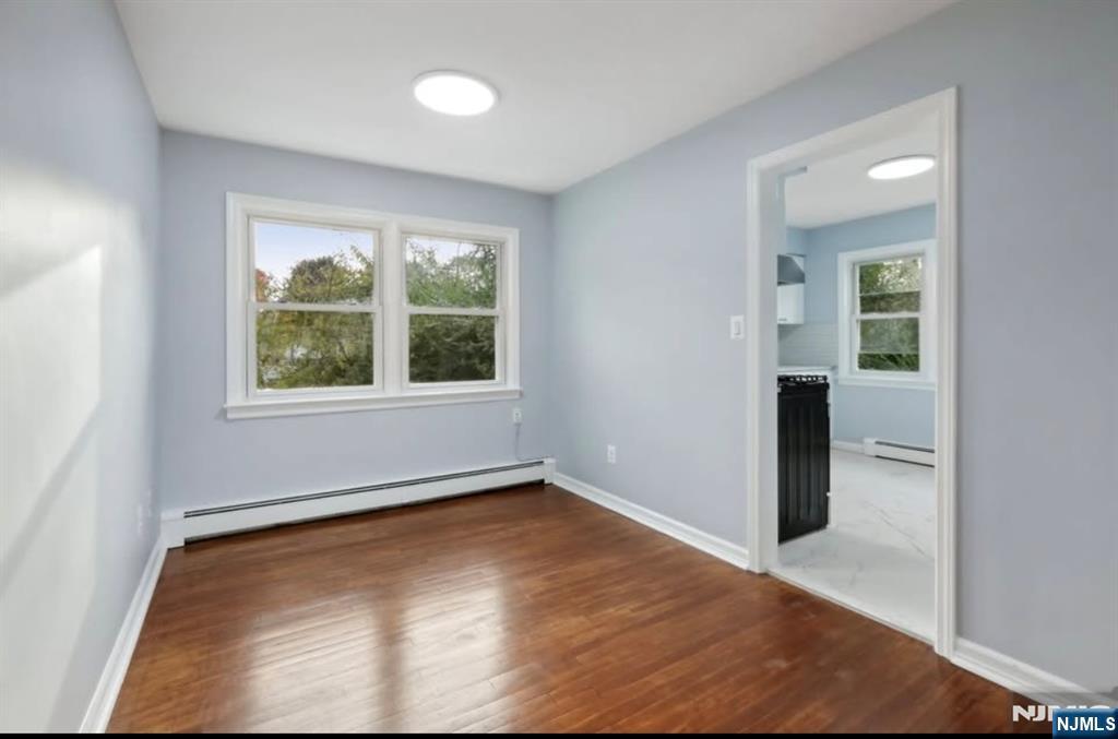 162 East Fairmount Avenue, Unit 2 Maywood, NJ 07607 - Photo 5 of 21 an empty room with wooden floor and windows