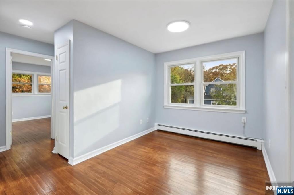 162 East Fairmount Avenue, Unit 2 Maywood, NJ 07607 - Photo 7 of 21 an empty room with wooden floor and windows