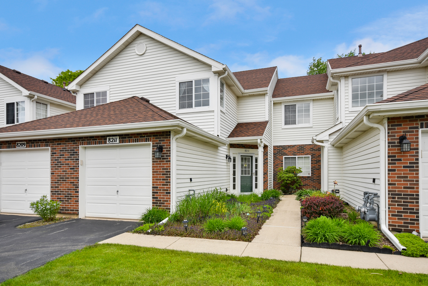 8211 Ripple Ridge Darien, IL 60561 - Photo 1 of 17 a front view of a house with a yard and garage