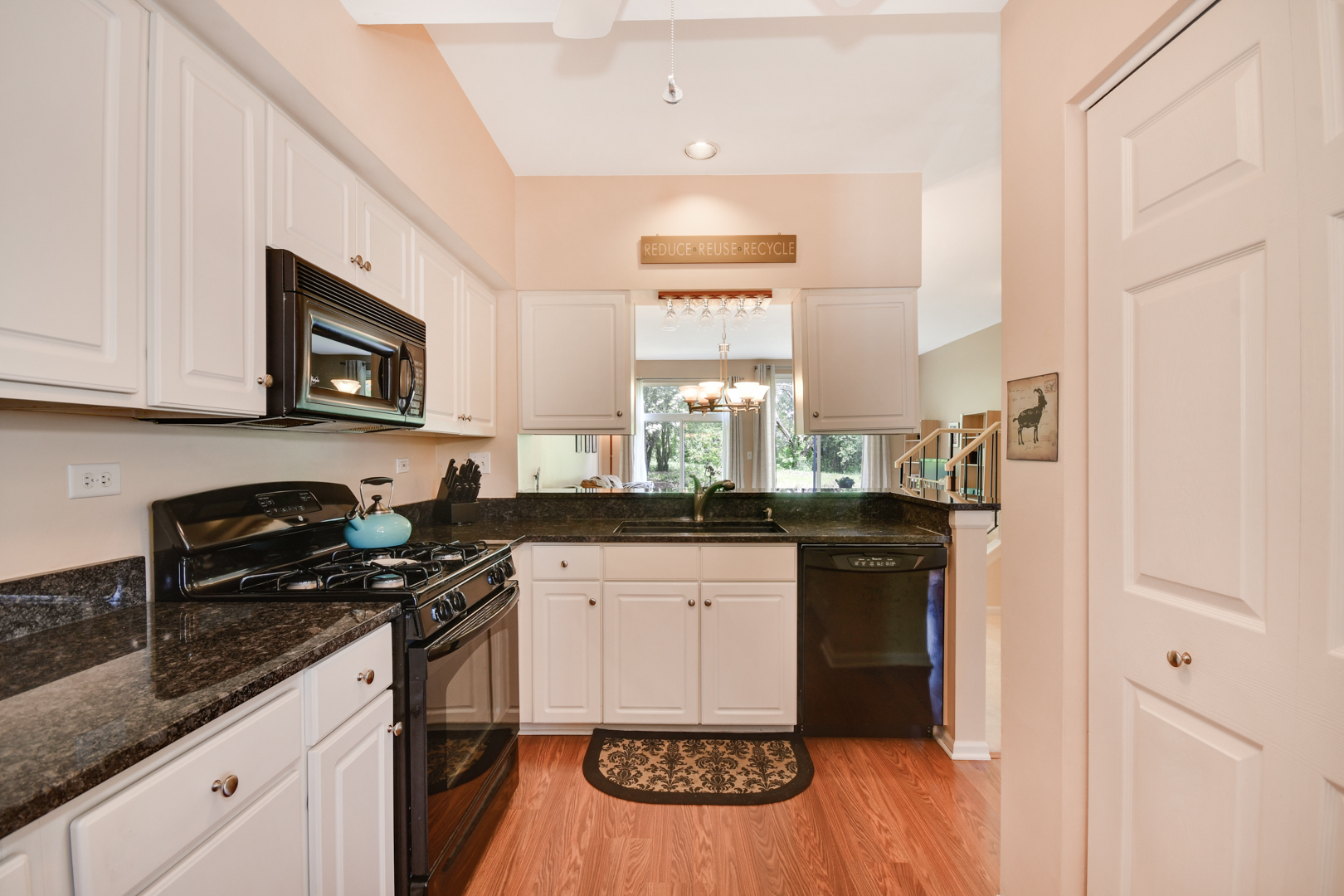 8211 Ripple Ridge Darien, IL 60561 - Photo 2 of 17 a kitchen with stainless steel appliances granite countertop a stove a sink and a microwave