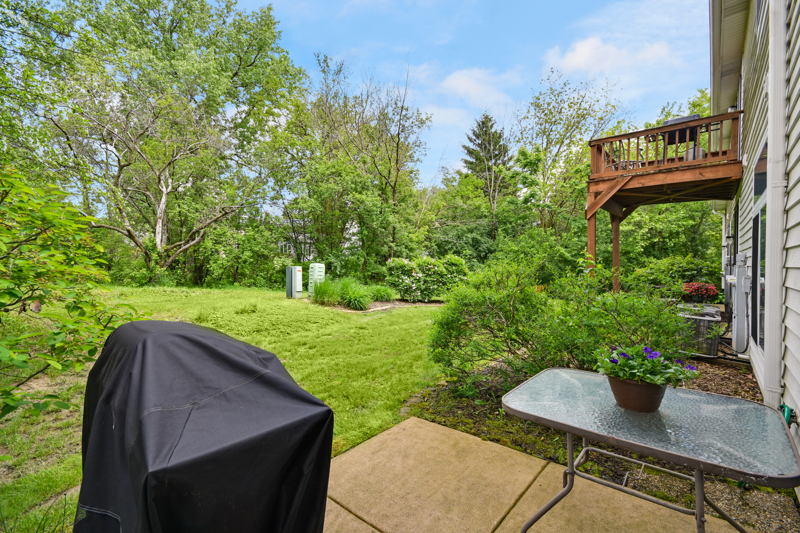 8211 Ripple Ridge Darien, IL 60561 - Photo 16 of 17 a backyard of a house with table and chairs plants and large trees