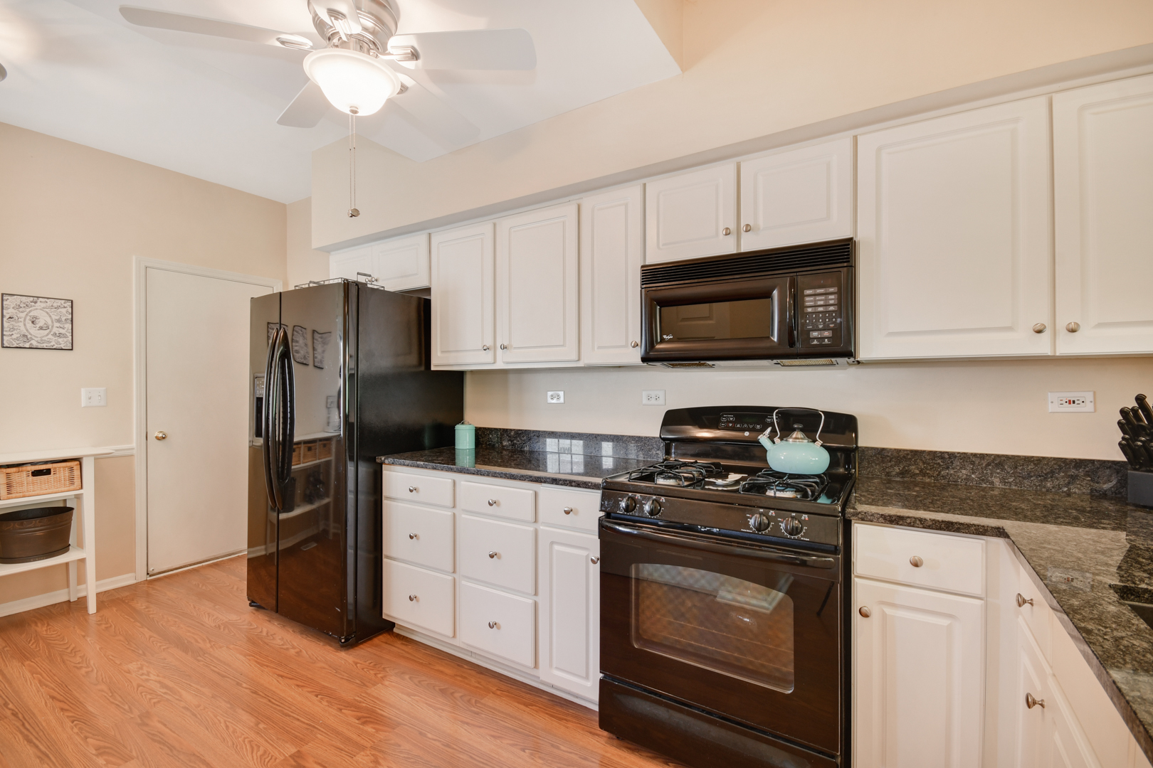 8211 Ripple Ridge Darien, IL 60561 - Photo 3 of 17 a kitchen with stainless steel appliances granite countertop a stove a refrigerator and a microwave