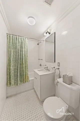 a bedroom with a bed wooden floor and window