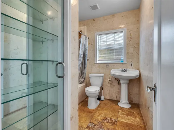 a bathroom with a sink toilet and shower