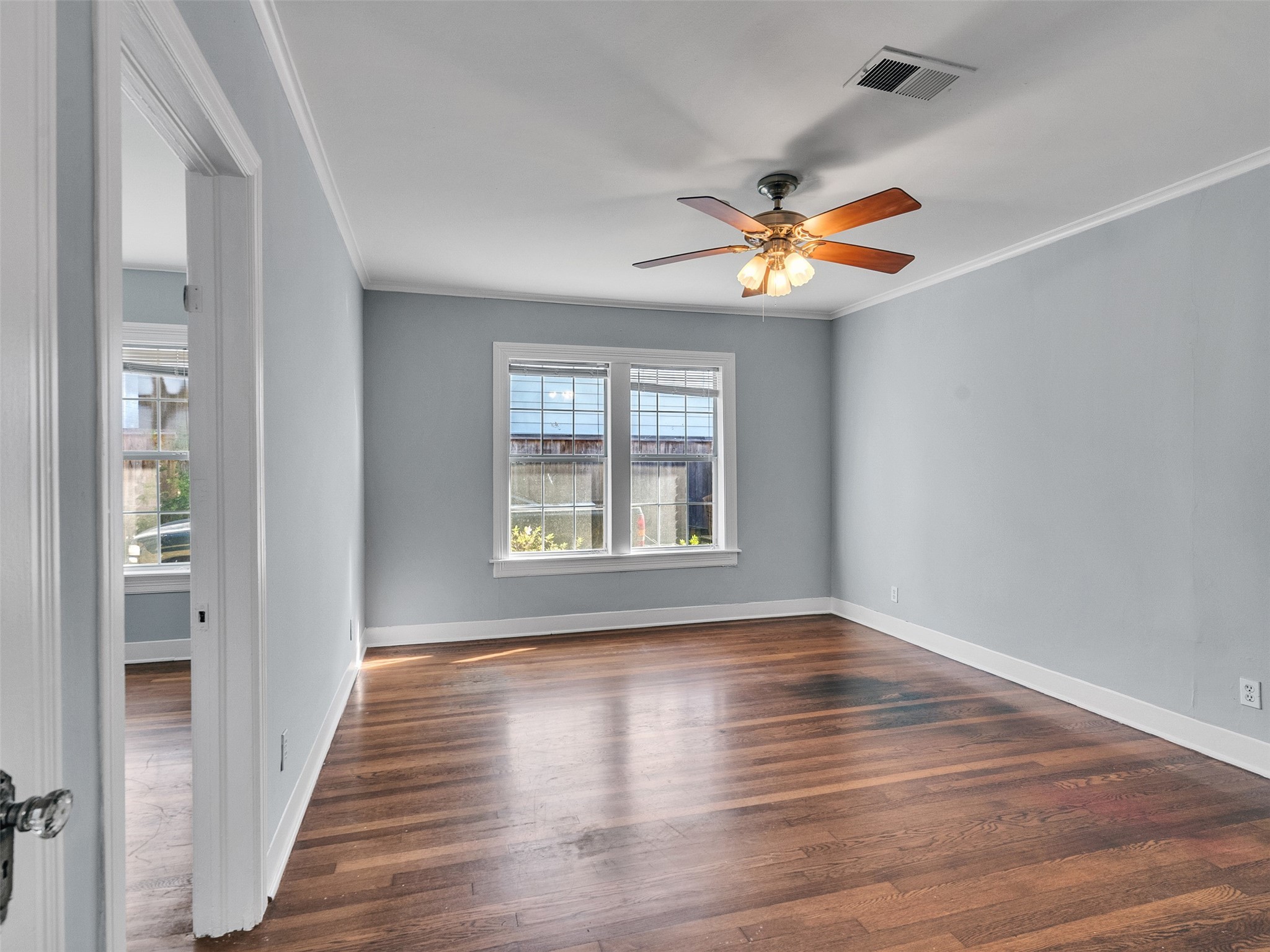 2141 Colquitt Street Houston, TX 77098 - Photo 17 of 50 a view of empty room with wooden floor and fan