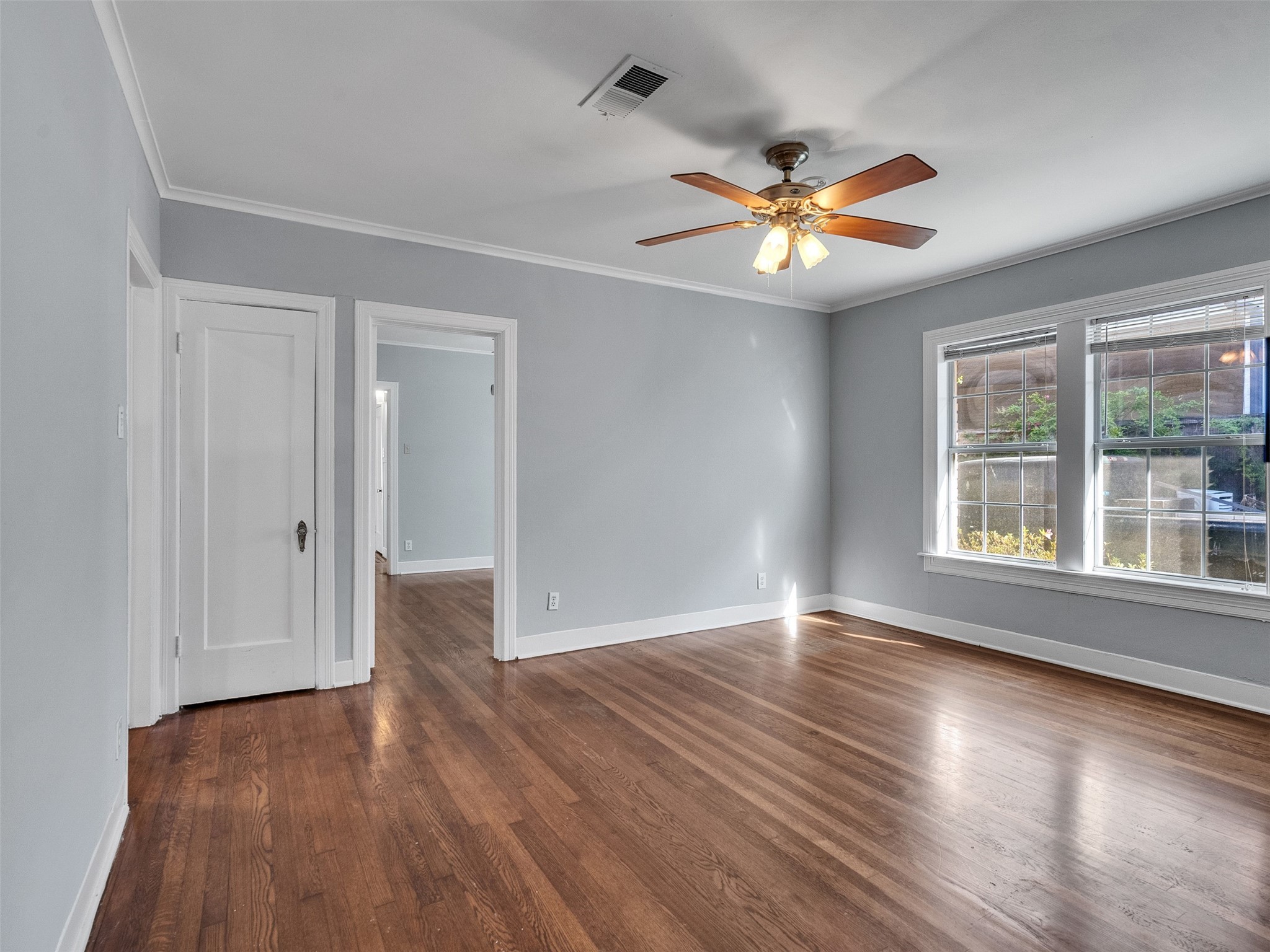 2141 Colquitt Street Houston, TX 77098 - Photo 18 of 50 a view of an empty room with window and wooden floor