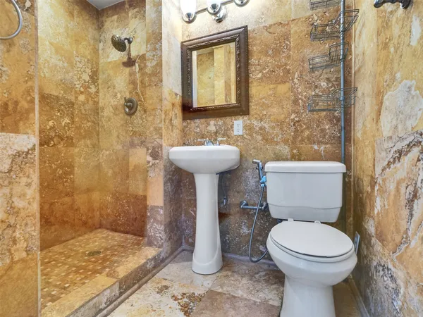 a bathroom with a toilet sink and shower