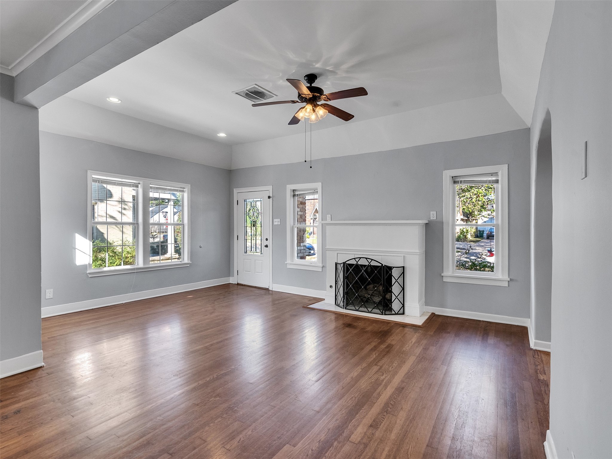 2141 Colquitt Street Houston, TX 77098 - Photo 24 of 50 an empty room with windows fireplace and wooden floor