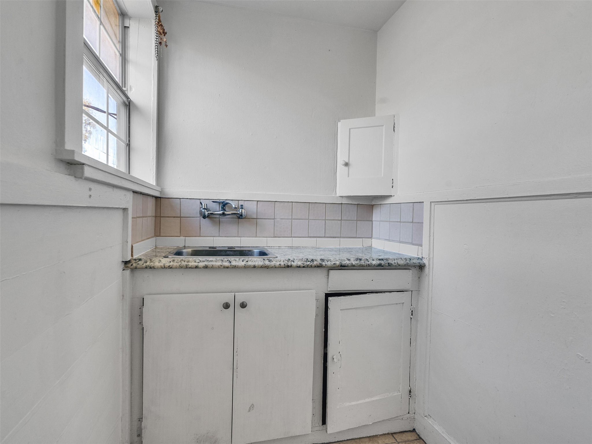 2141 Colquitt Street Houston, TX 77098 - Photo 37 of 50 a bathroom with a granite countertop sink and a mirror