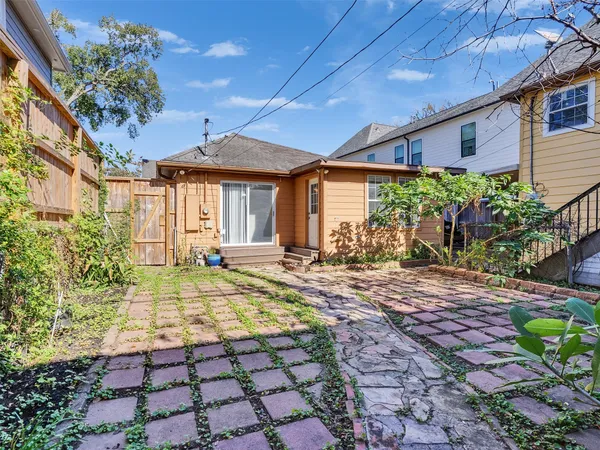 a view of a house with a small yard and plants