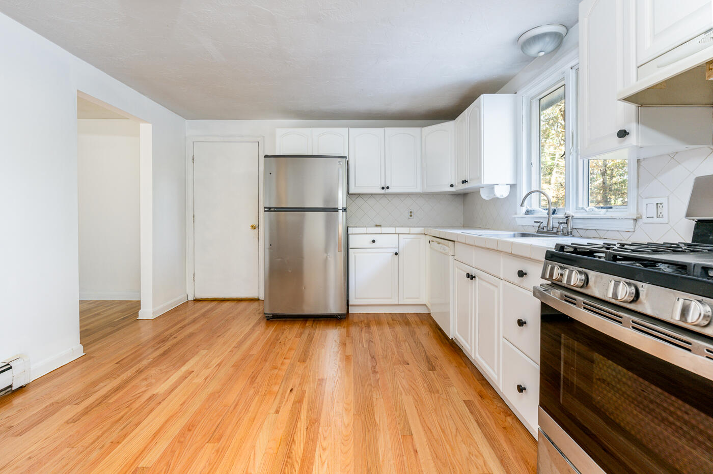 40 Goose Point Road Centerville, MA 02601 - Photo 5 of 30 a kitchen with a sink a refrigerator and a stove top oven