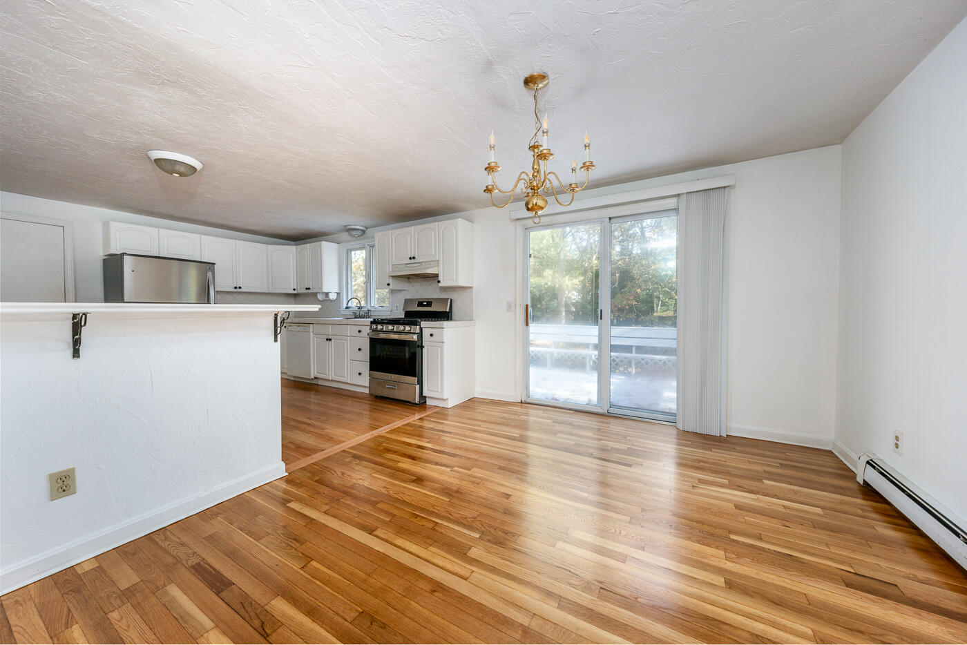 40 Goose Point Road Centerville, MA 02601 - Photo 7 of 30 a view of a kitchen with wooden floor a sink a refrigerator and windows