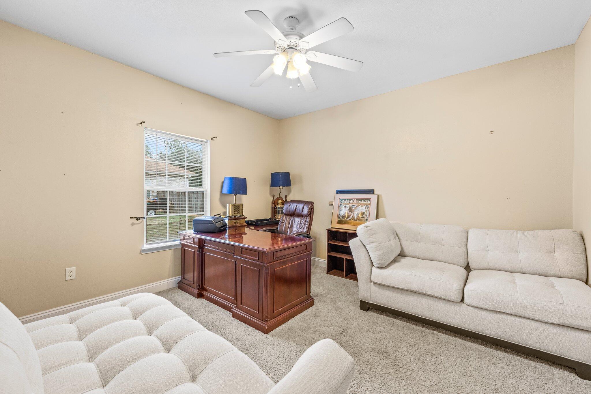 901 Shoal River Drive Crestview, FL 32539 - Photo 21 of 56 a living room with furniture and a large window
