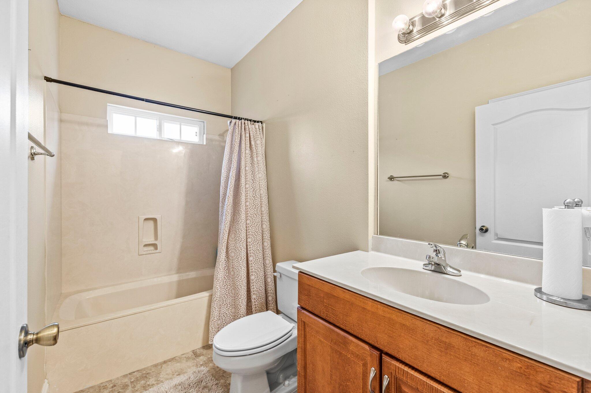 901 Shoal River Drive Crestview, FL 32539 - Photo 24 of 56 a bathroom with a granite countertop sink toilet and shower