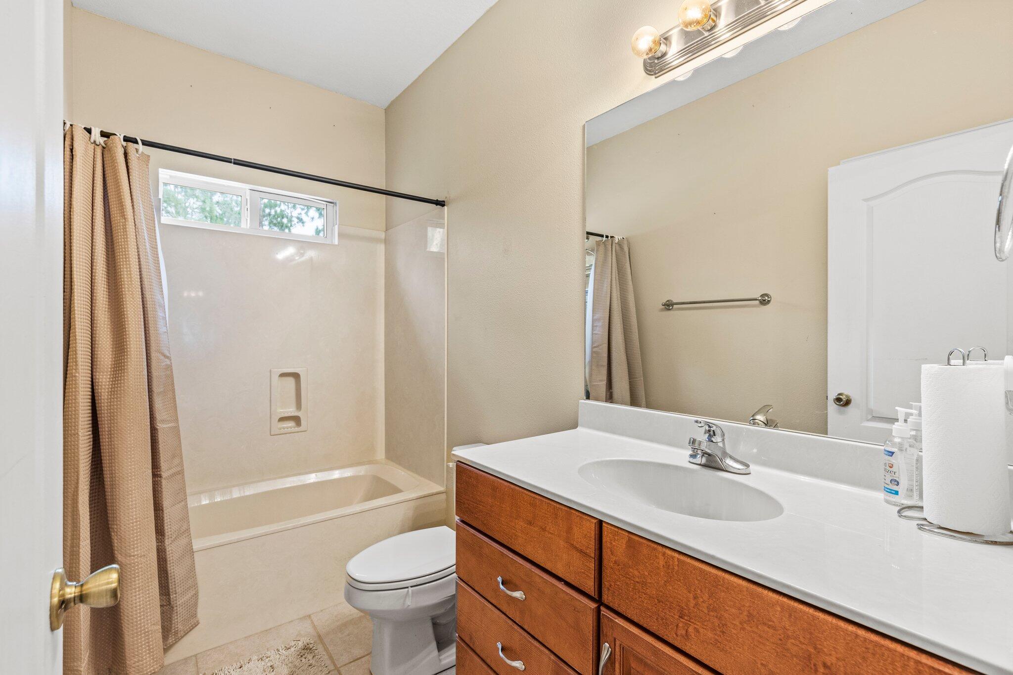 901 Shoal River Drive Crestview, FL 32539 - Photo 28 of 56 a bathroom with a granite countertop sink toilet and shower