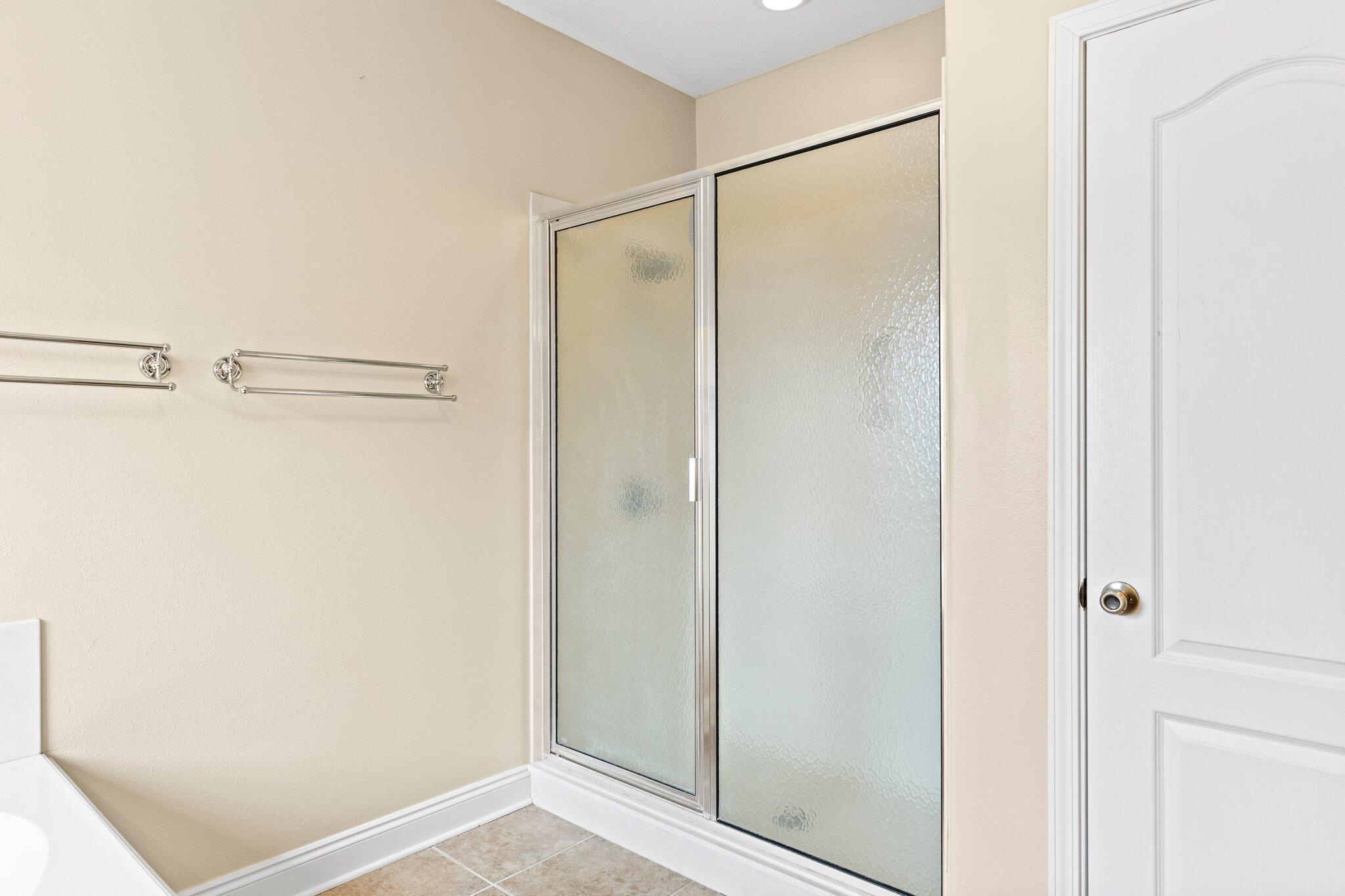 901 Shoal River Drive Crestview, FL 32539 - Photo 38 of 56 a bathroom with a glass shower door