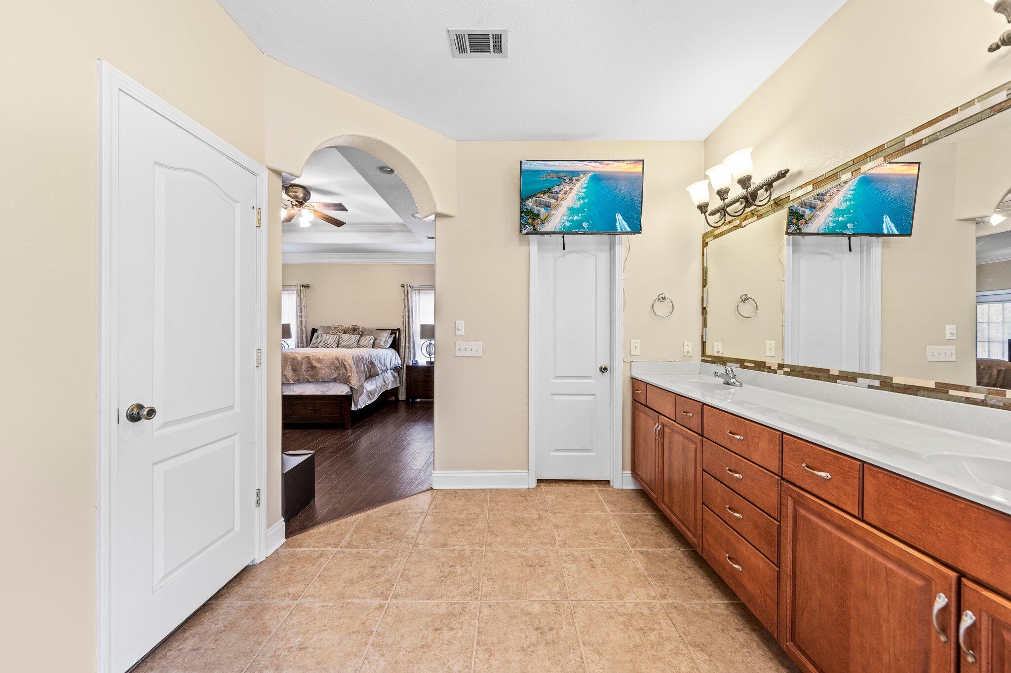 901 Shoal River Drive Crestview, FL 32539 - Photo 39 of 56 a en suite bathroom with a double vanity sink and a mirror