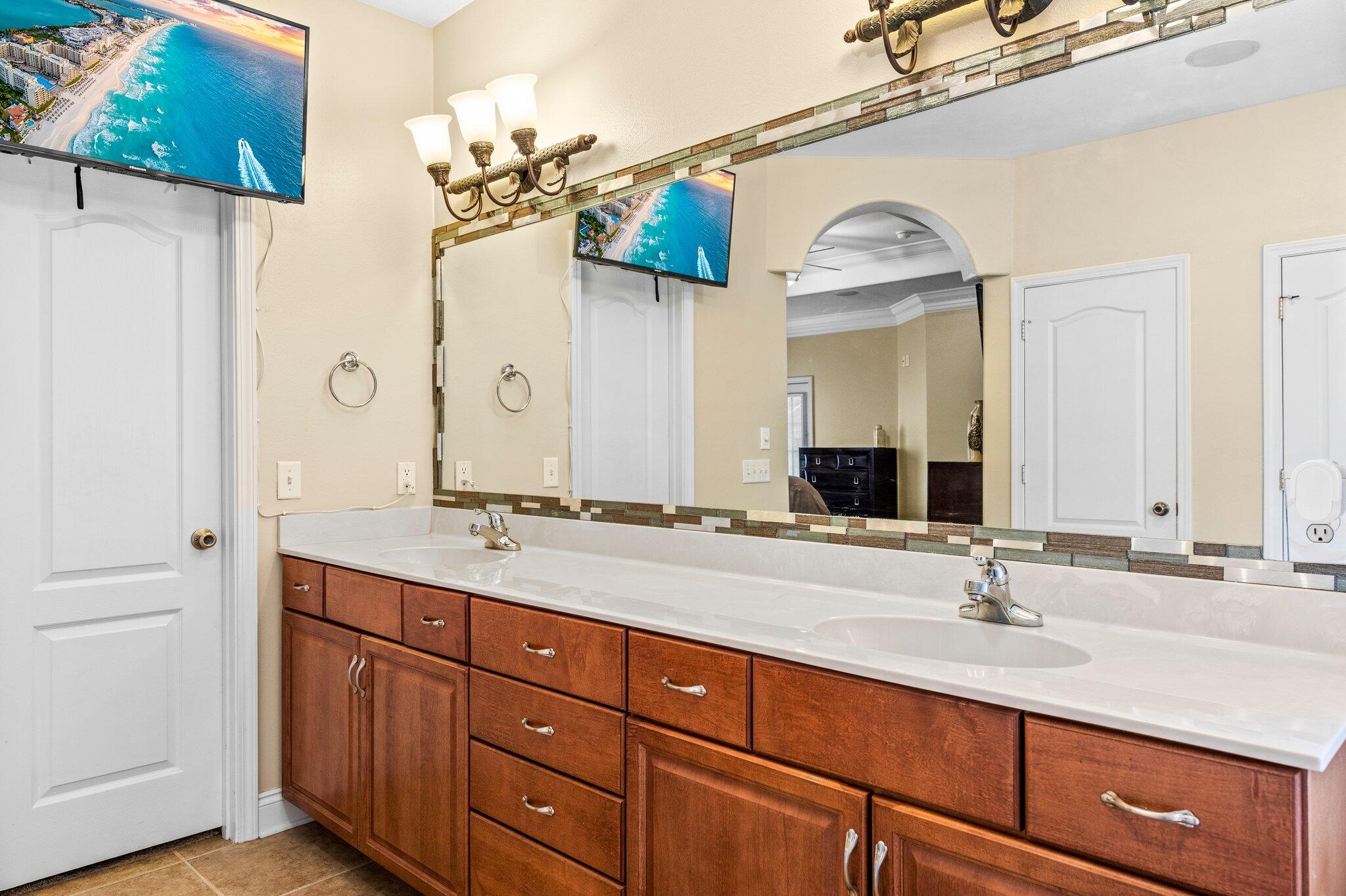 901 Shoal River Drive Crestview, FL 32539 - Photo 40 of 56 a bathroom with a granite countertop sink and a mirror