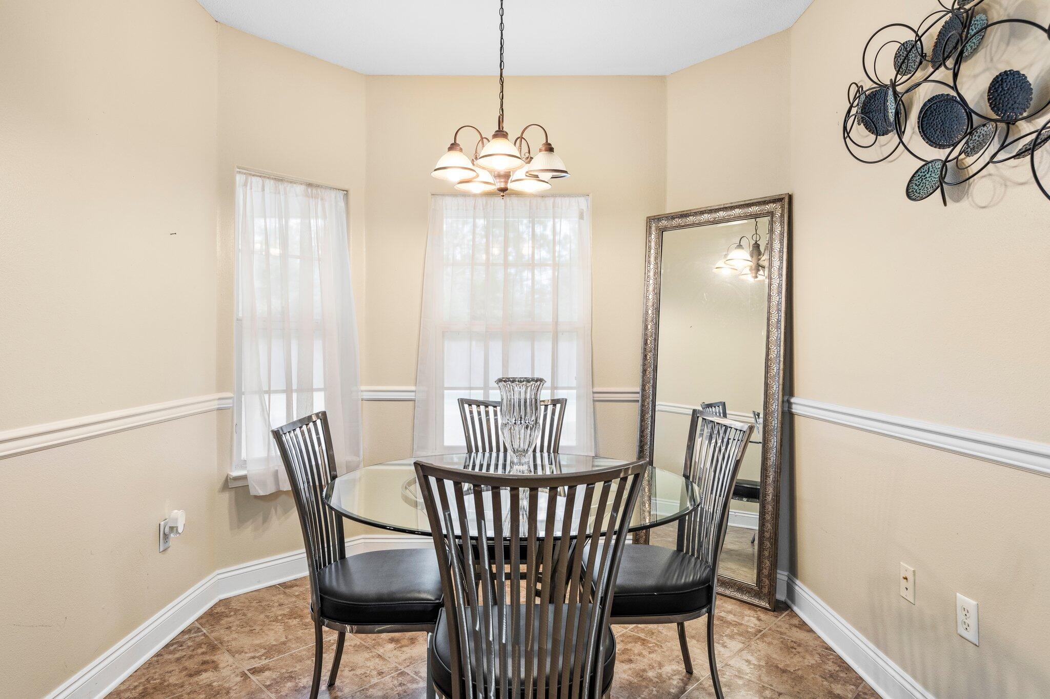 901 Shoal River Drive Crestview, FL 32539 - Photo 42 of 56 a view of a dining room with furniture window and wooden floor