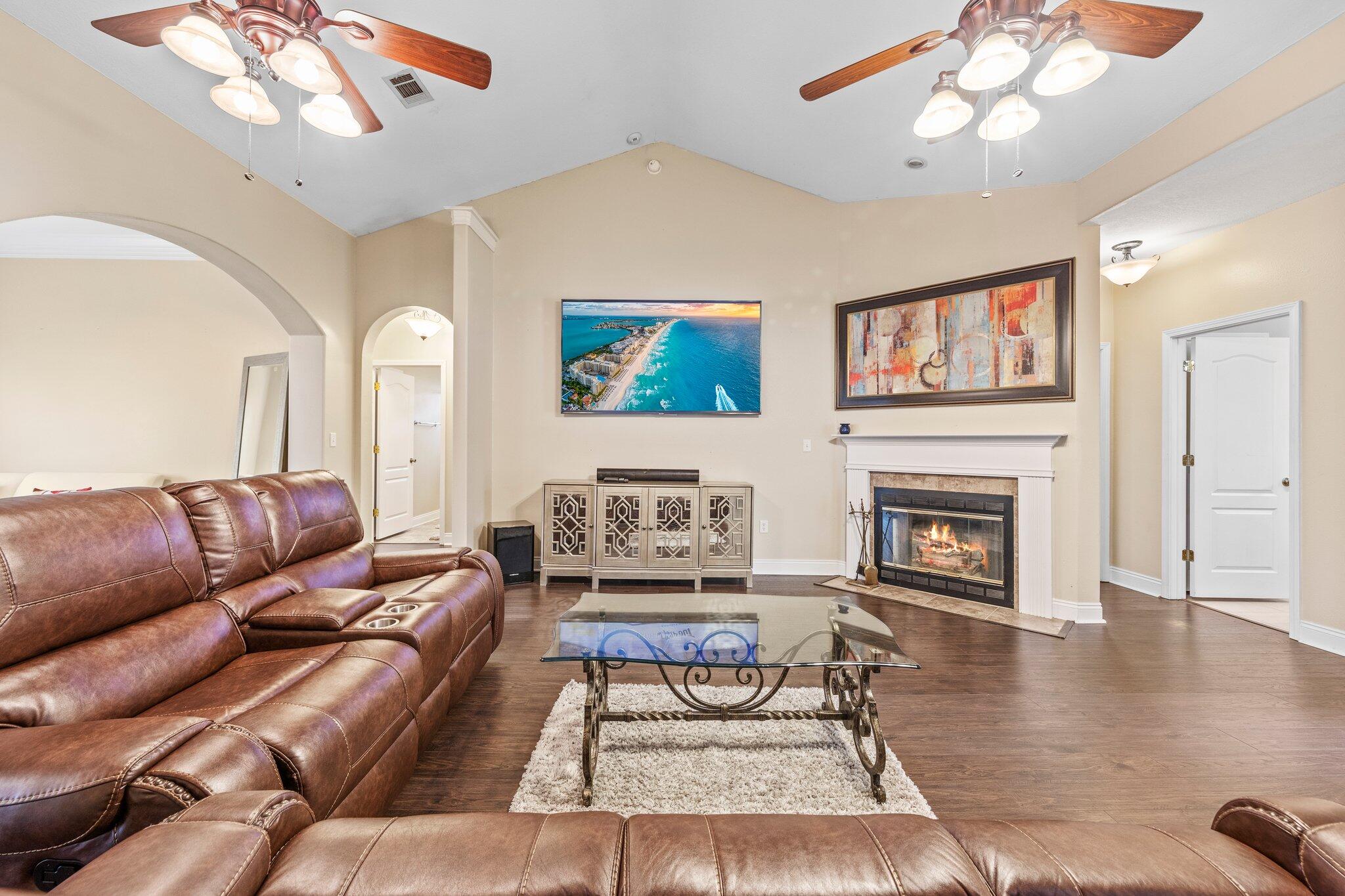 901 Shoal River Drive Crestview, FL 32539 - Photo 50 of 56 a living room with furniture a fireplace and a chandelier