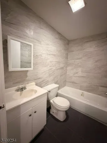 a bathroom with a sink a toilet and bathtub