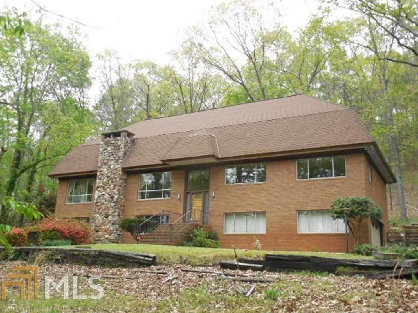 2872 Horseleg Creek Road Southwest Rome, GA 30165 - Photo 1 of 1 a front view of a house with a garden and plants