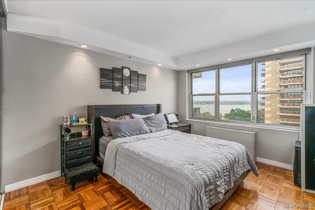 a bedroom with a bed and a large window