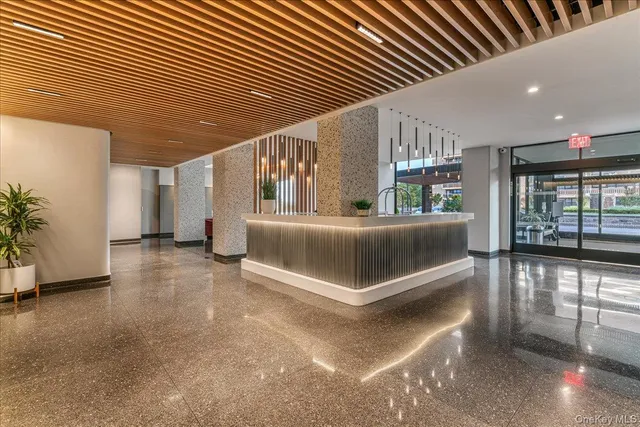 a bedroom with furniture and large window