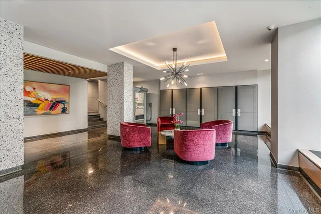 a living room with furniture and a chandelier